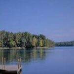 A serene dock on a picturesque lake in New Hampshire.
