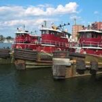 A group of tugboats docked in the water in New Hampshire.