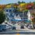 A street in a small town in New Hampshire with cars parked in the street.