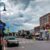 A street in New Hampshire with cars parked on it under a cloudy sky.