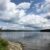 A scenic view of a lake in New Hampshire, with clouds decorating the sky.