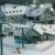 A picture of a ski resort in New Hampshire with skiers and snowboarders.