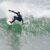 A surfer riding a wave in the ocean off the coast of New Hampshire.