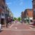 A brick street lined with shops and a clock in New Hampshire.